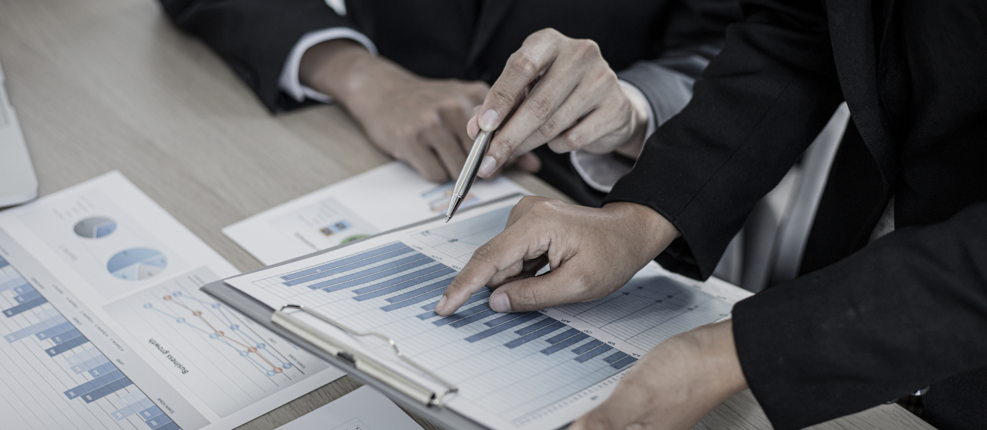 Consultants reviewing performance reports together